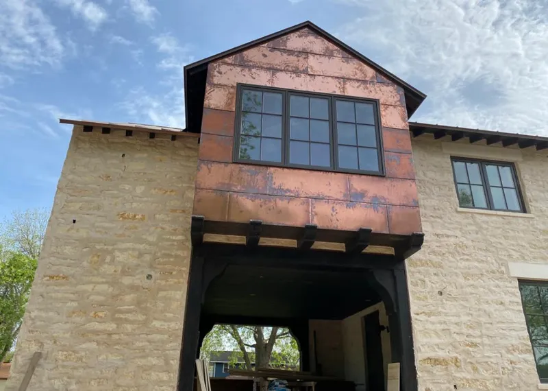 Copper metal panel facade on a stone building for Roof Repair in Pryor Creek